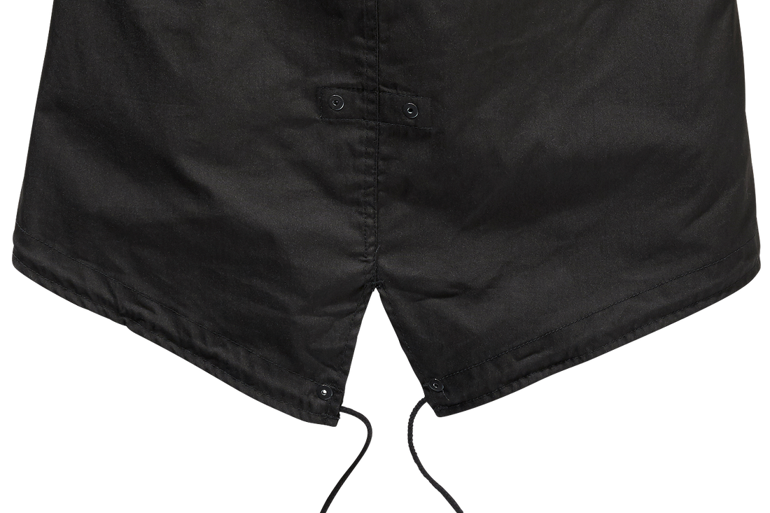 Close-up of the bottom hem of the Callisto M51 US Parka Jacket, showing its black military style with a pointed fishtail design, two snap buttons, and adjustable drawstrings hanging down.