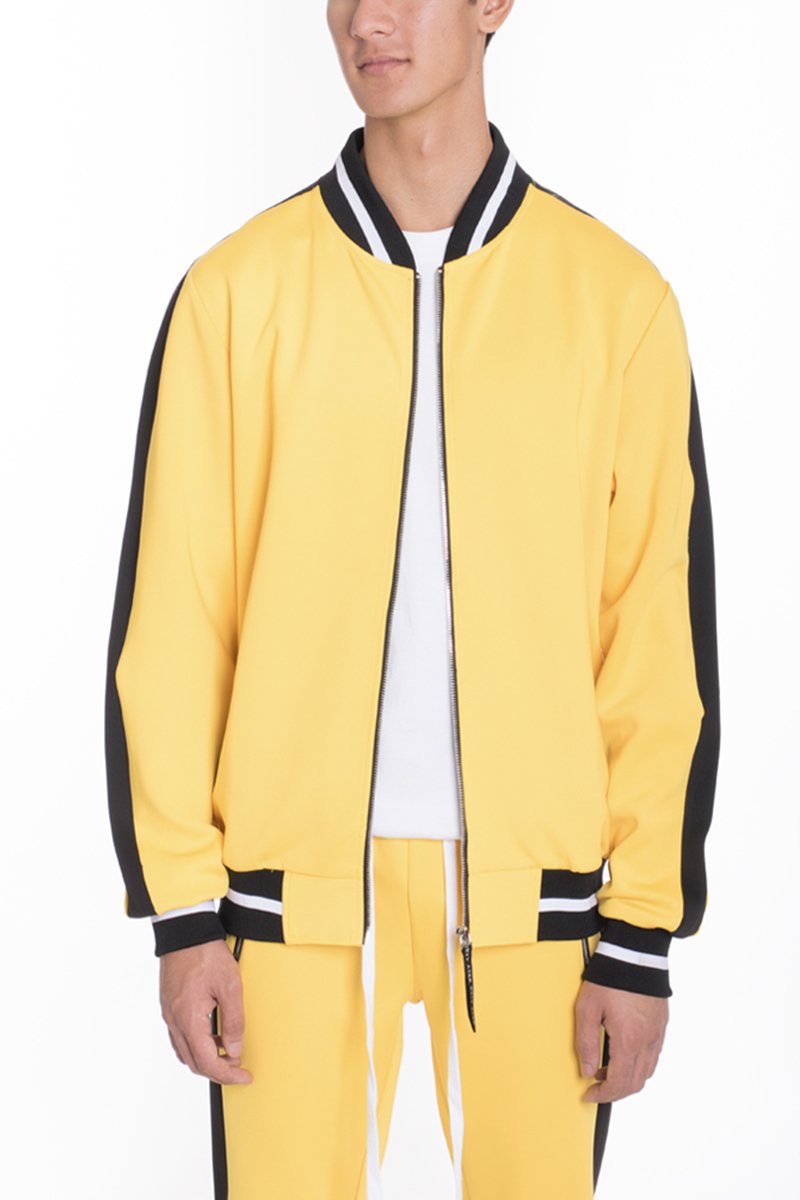 A person wearing the Lime Milo Heavy Weight Solid Track Jacket in yellow with black sleeve stripes and matching yellow pants stands against a plain white background.