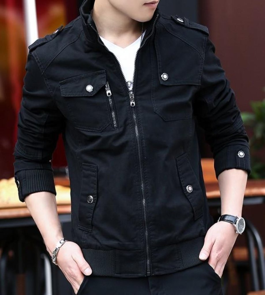 A person wearing the Yellow Pandora Mens Military Theme Short Jacket in black, styled with buttoned pockets over a white shirt, plus a wristwatch and bracelet. Hands are in pockets; face is not visible.
