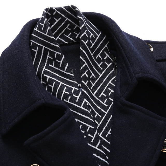 A close-up of the Teal Simba Winter Scarf Detachable Scarf Jacket men's wool coat in navy, highlighting its black and white geometric patterned lining inside the collar.