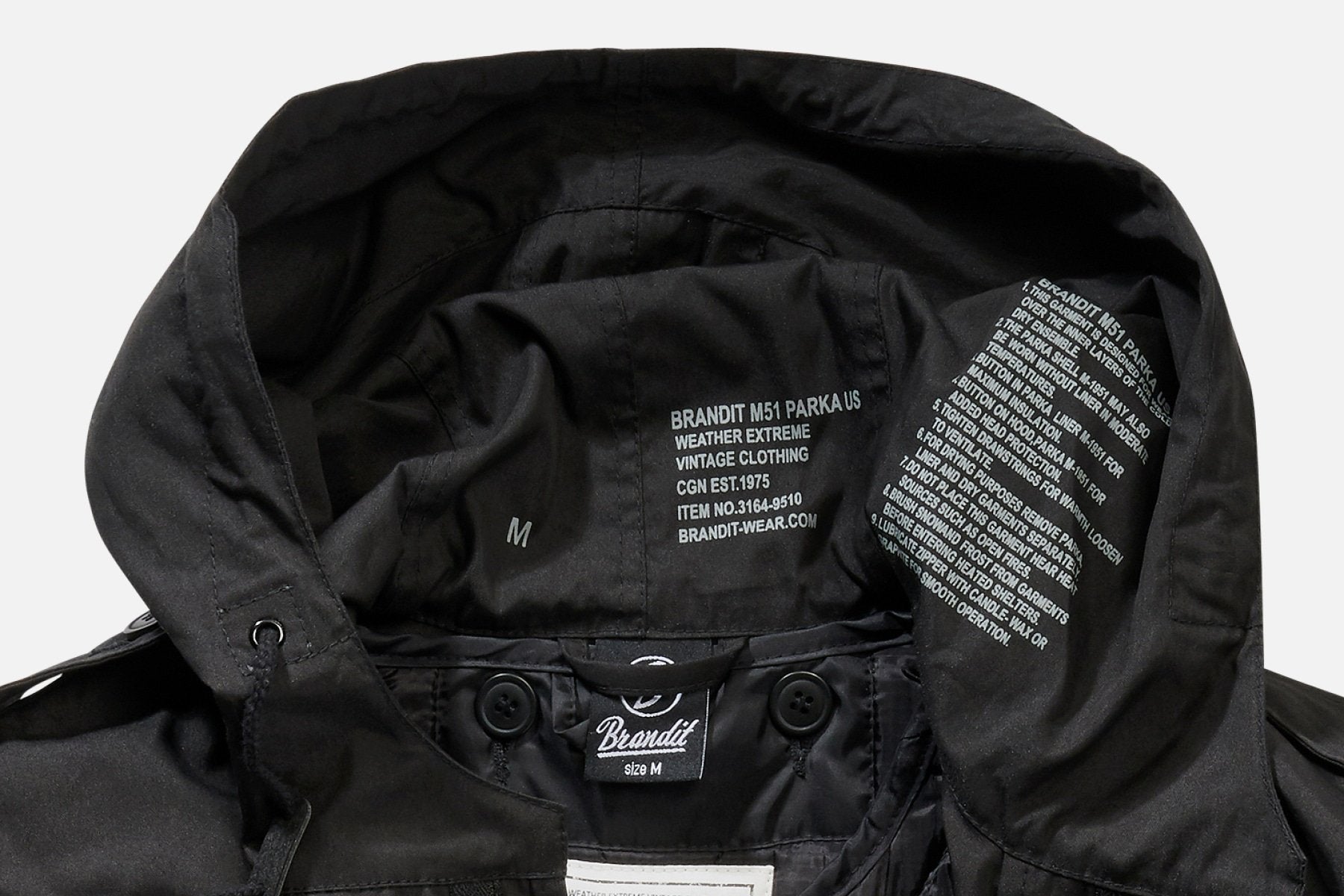 Close-up of the inside hood of a black Callisto M51 US Parka Jacket, showing size M tags, care instructions, and the brand label printed in white on the inner fabric.